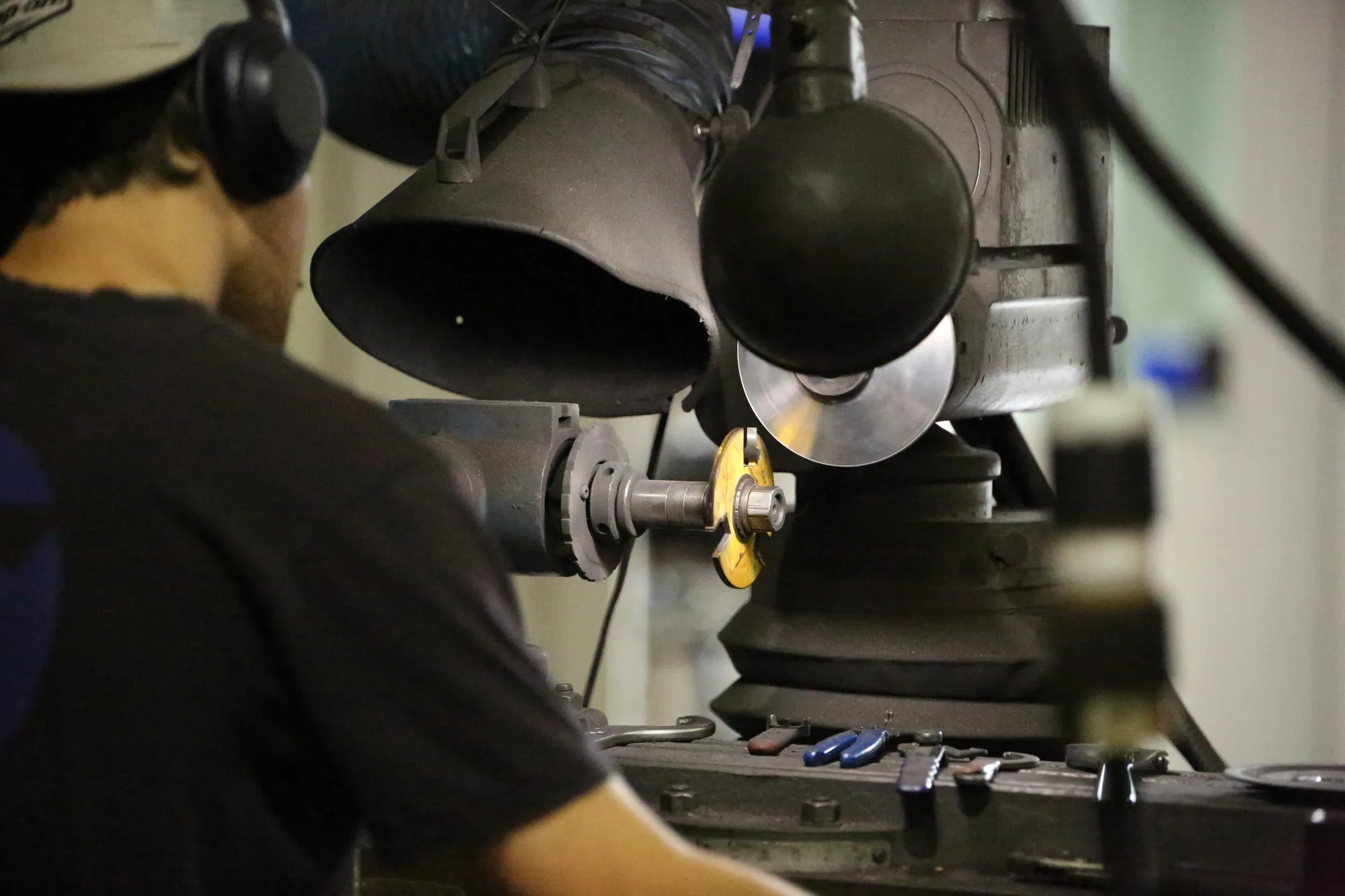 Technician sharpening a router bit at Byler Industrial Tool