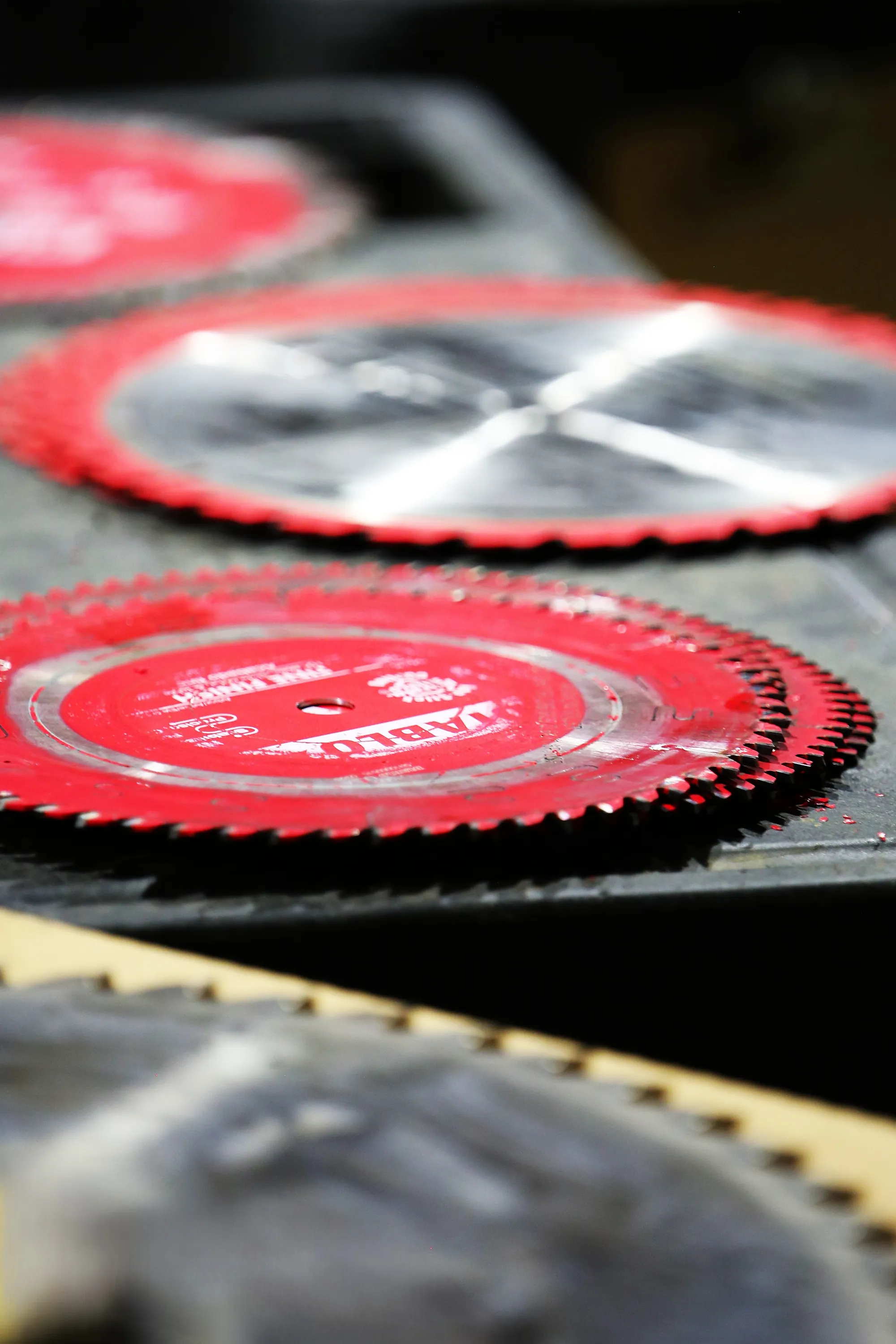 Stacked carbide circular saw blades ready for sharpening at Byler Industrial Tool